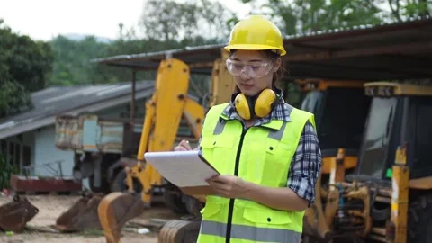A female mechanic is checking items in the heavy garage1 Stock Footage 135515046