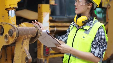 A female mechanic is checking items in the heavy garage15 Stock Footage 135515051