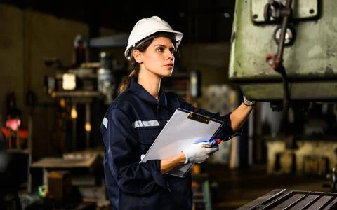 Female mechanical engineer manager checking and inspecting engine machine 스톡 사진
