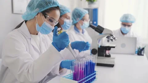 Female medic examining test tubes Video stock 171673138