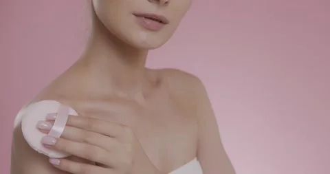 Female model applying powder on bare shoulders with sponge Stock Footage 158755576