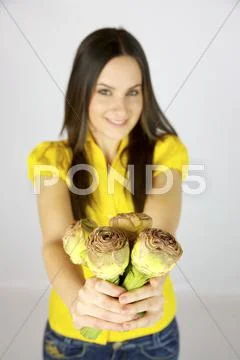 Female model with artichokes in her hands Stock Photos