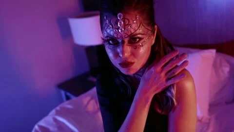 A female model with a beautiful makeup, a pattern and with rhinestones on her Video stock 147372177