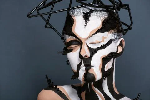 Female model with creative abstract makeup in futuristic hat Stock Photos