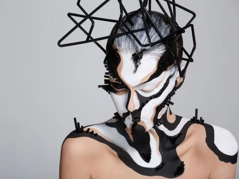 Female model with creative abstract makeup in futuristic hat Stock Photos