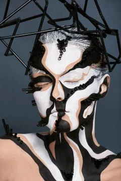 Female model with creative abstract makeup in futuristic hat Stock Photos