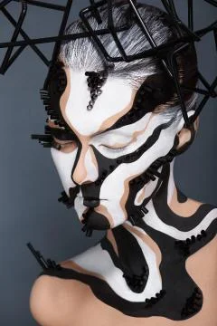 Female model with creative abstract makeup in futuristic hat Stock Photos