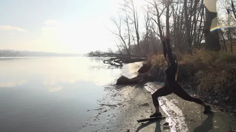 Female model doing yoga by river Stock Footage 33666077