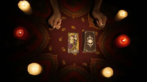 Female model hands picking one tarot card from the deck, placing it on the table Stock Photos