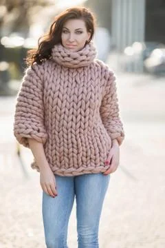 Female model outside spring in warm knitted sweater Stock Photos