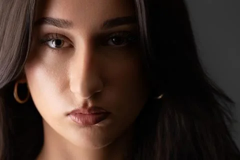 Female model portrait with dramatic studio lighting and intense gaze Stock Photos