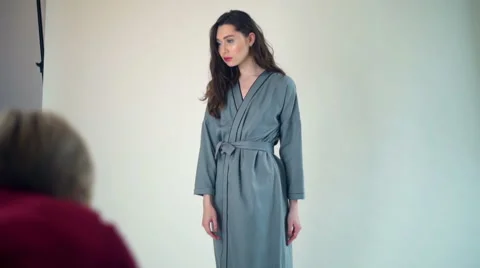 Female model posing in bathrobe in studio slow motion Stock Footage 62199174