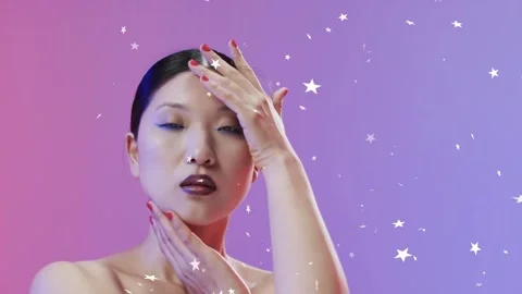 Female model posing in beauty shoot camera pulling back showing makeup stars Stock Footage 334316482