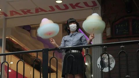 Female model posing with candyfloss in front of store in Harajuku. Tokyo, Japan. Stock Footage 247827796