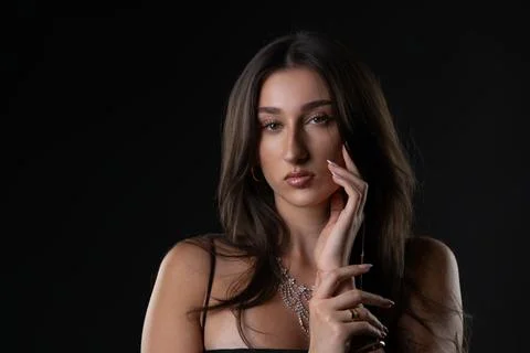 Female model posing with hand on face showing beauty Stock Photos