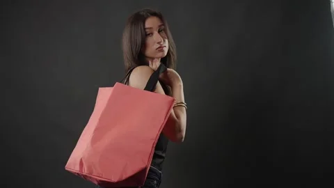 Female model posing with reusable shopping bag, sustainable fashion and Stock Footage 336937103