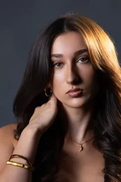 Female model posing in studio with split lighting Stock Photos