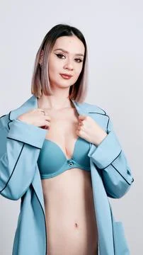Female model posing in a stylish light blue trench coat robe Stock Photos