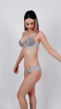 Female model posing in subtle gray seamless lingerie set Stock Photos