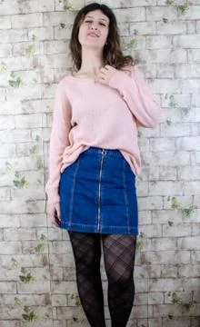 Female model posing on wall Stock Photos