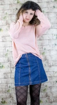 Female model posing on wall Stock Photos