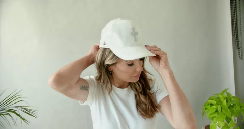 Female Model Putting on Hat Stock Footage 139374738