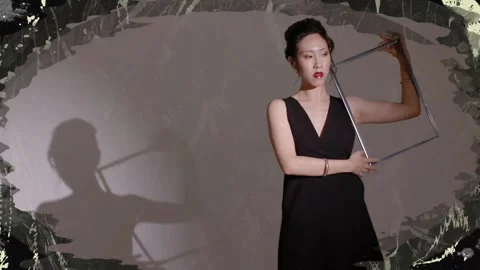Female model raising frame, rotating it to frame face and creating shadow Stock Footage 334316462