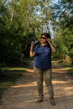 A female model on road with camera Stock Photos