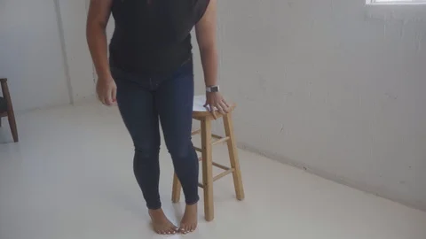 Female model sitting on stool in studio Stock Footage 111593487