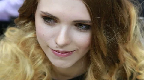 Female model smiling while her blond hair being combed in a fashion hairsyle Stock Footage 48624633