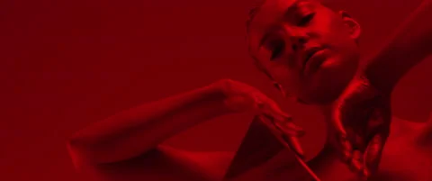 Female model touching face and performing sensual moves in red neon illumination Stock Footage 160287660