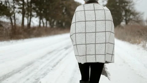 Female model under snowfall in winter forest landscape on blurred background. Stock Footage 292152397