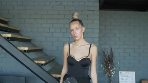 Female model walks down the corridor of the house in shoes and shows off outfit 스톡 동영상 158351139