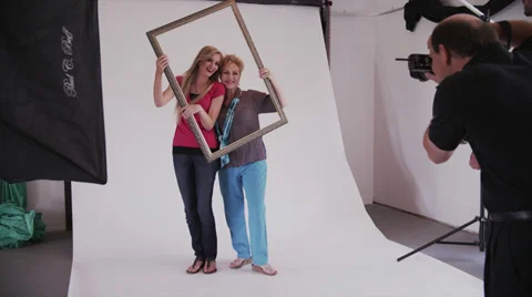 Female Models Play with Frame in Photo Shoot Stock Footage