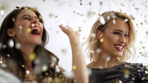 Female models posing under shower of confetti Video stock 121668736