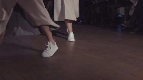 Female models walk the runway in different dresses during a Fashion Show Stock Footage 105864487