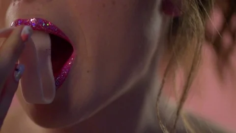 A female mouth eats a long chewing gum. Stock Footage 77609106