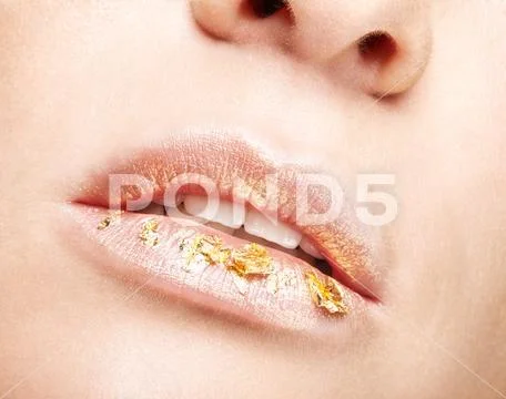 Female mouth with sparkles on lips. Closeup macro beauty portrait of young wo Stock Photos