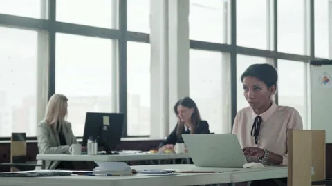 Female multi-ethnic manager working in office with laptop. Young business team Stock Footage 134167439