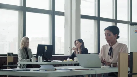 Female multi-ethnic manager works in office with laptop and communicates with Stock Footage 124272391