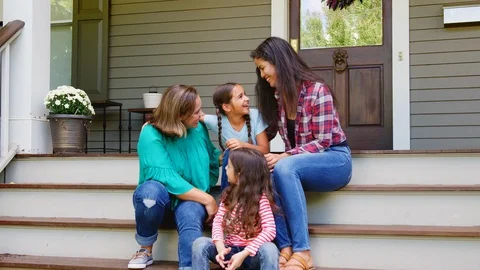 Female Multi Generation Family Sit On Steps in Front Of House Stock Footage