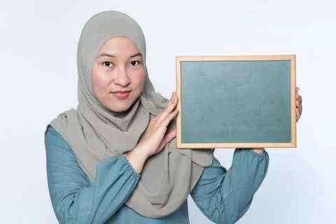 Female muslim woman holding a chalk board. Stock Photos