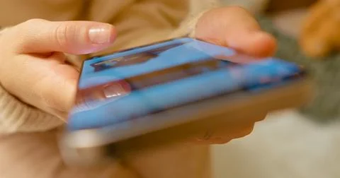 Female navigating digital platform with focused thumb movements Stock Photos