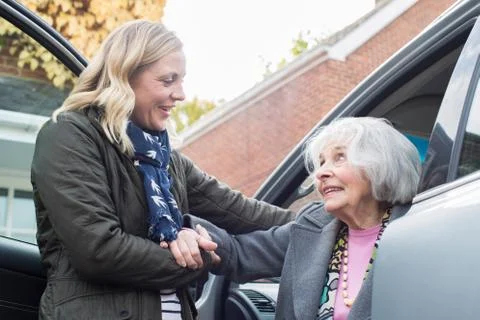 Female Neighbor Giving Senior Woman A Lift In Car Stock Photos