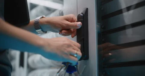 Female Network Engineer Accessing Server Hardware in Data Center Corridor Stock Footage 344880069