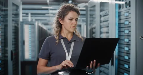 Female Network Engineer Configuring Server Hardware on Laptop Stock Footage 344881893
