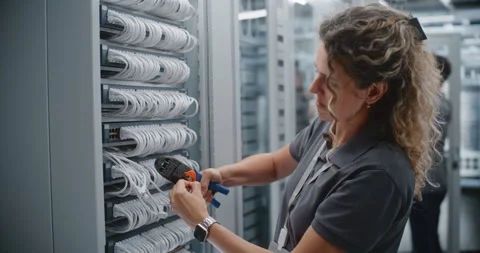 Female Network Engineer Terminating Cat6 Cable with RJ45 Connector in Data Stock Footage 344976627