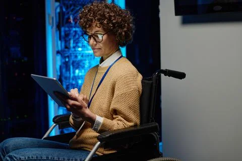 Female network engineer in wheelchair using tablet pc Stock Photos