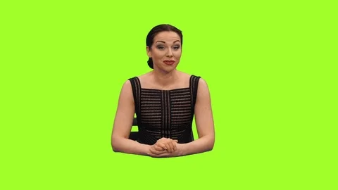 Female news reporter sitting in a studio and talking on green screen background Stock Footage