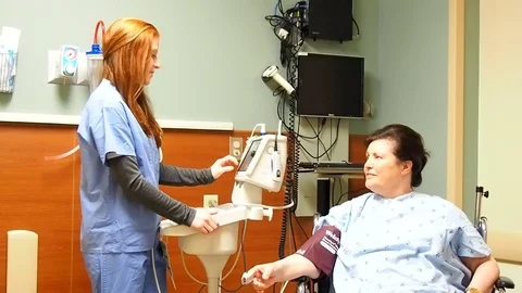 Female nurse checking patient Stock Footage 70686958